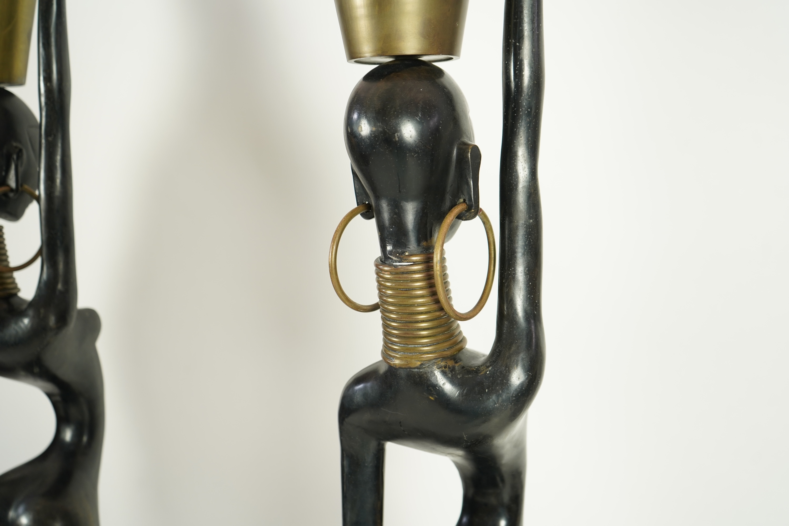 A large pair of Hagenauer style ebonised bronze 'Giraffe Woman' figures